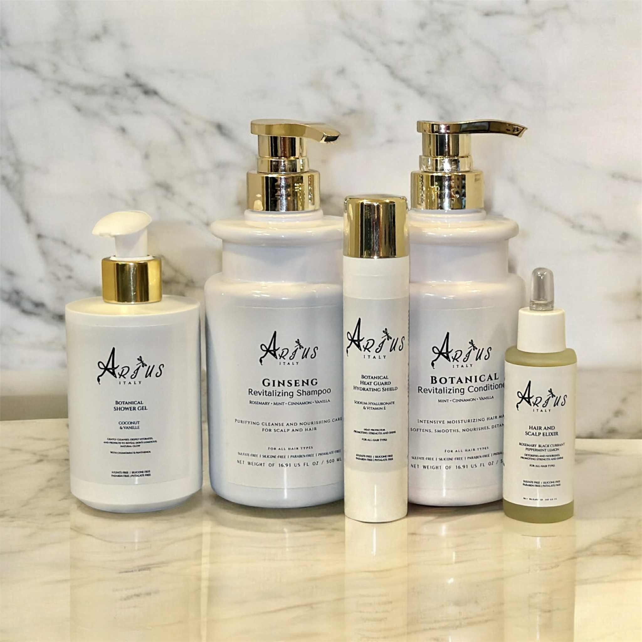 Set of Arius bath and hair products on a marble surface with a marble background
