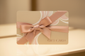 A gift card with a ribbon around the card like a present