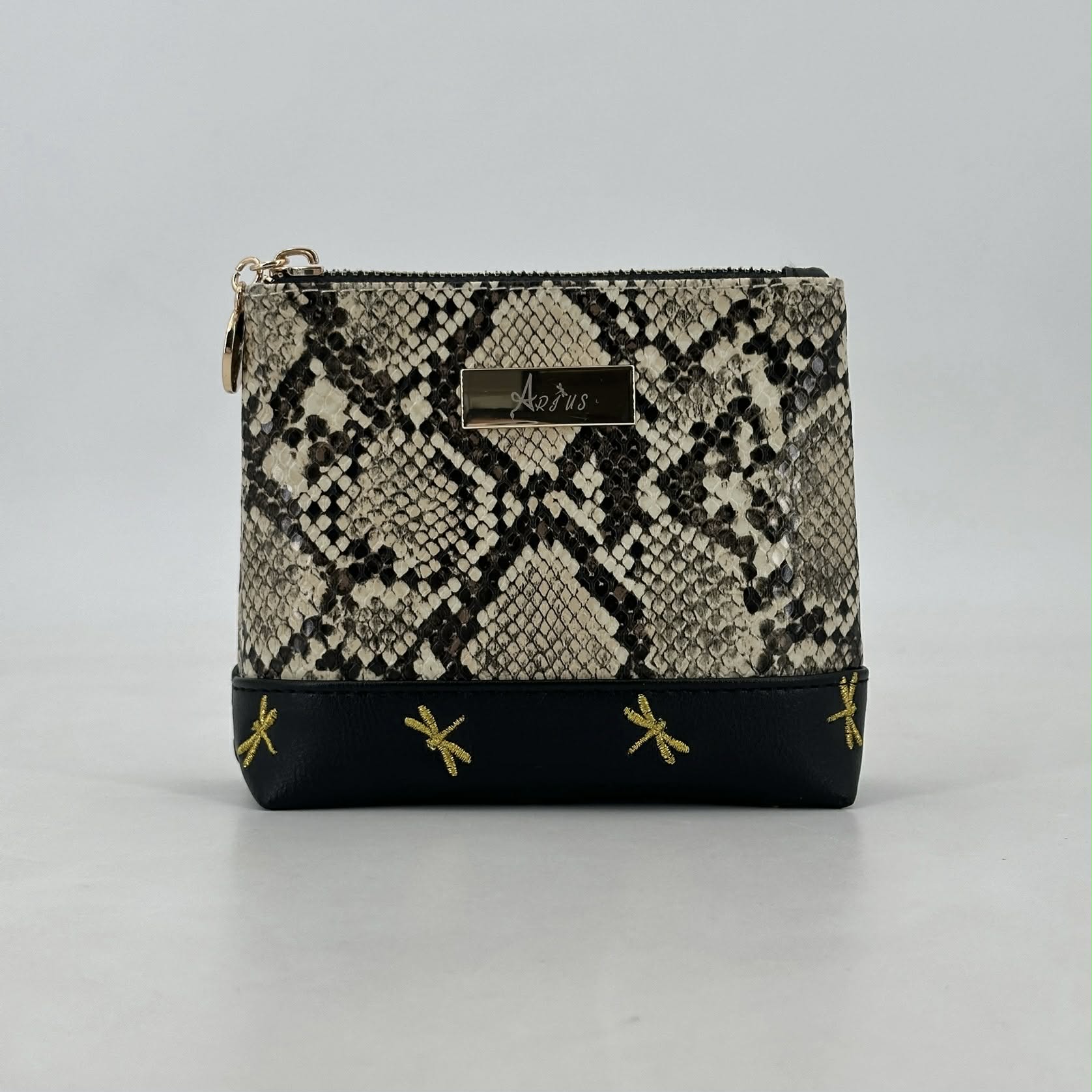 Snakeskin patterned pouch with black base and gold accents on a gray background